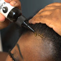 Hair Growth Oil being applied directly to scalp, targeting hairline to boost hair strength and promote healthy growth with nutrient-rich formula.